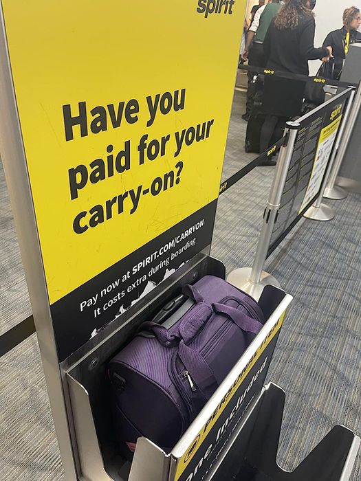 the suitcase being measured in Spirit Airlines' carry-on size checker