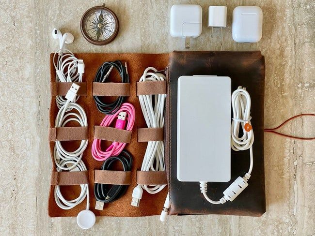 An overhead view of the organizer filled with various cords neatly arranged inside.