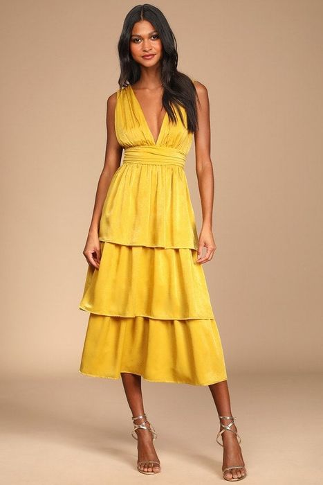 a mustard yellow dress with three ruffled tiers