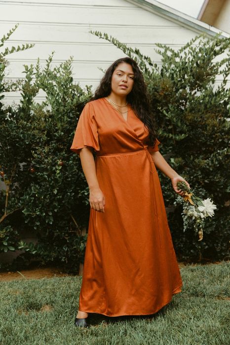 A model posing in the rust orange color.