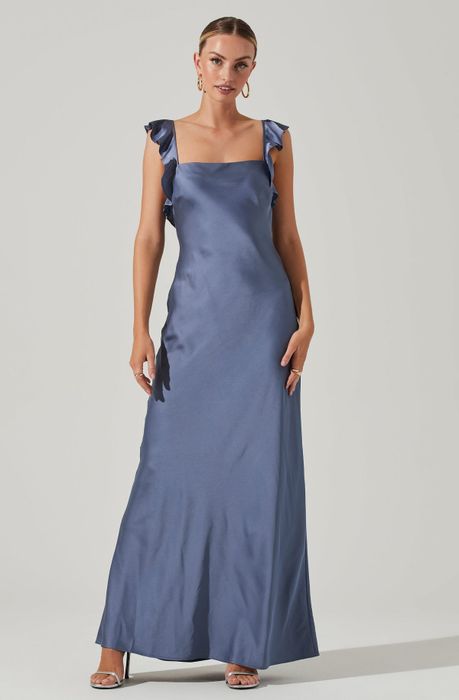 a model striking a pose in the blue dress