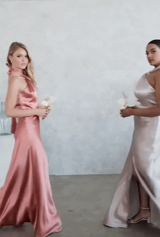 A GIF of two models posing in pink and taupe.