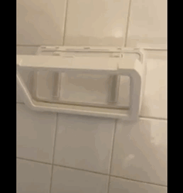 A reviewer's photo showing them rotating the shower phone holder.