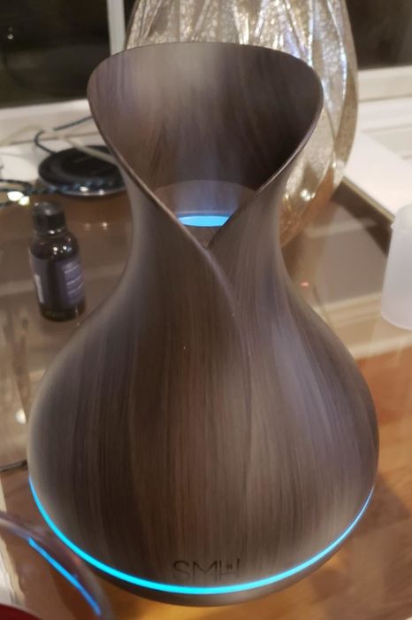 A photo from a reviewer showcasing the diffuser with a band at its base glowing in blue.