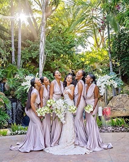 a bride and her bridesmaids wearing the purple gown