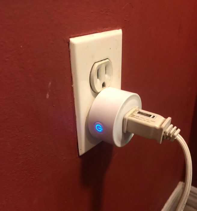 A smart plug connected to a wall outlet.