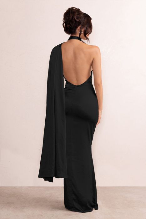a model showcasing the open back of the black gown