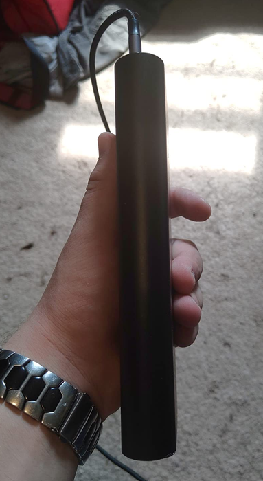 A reviewer's photo showing the profile view of the power bank.