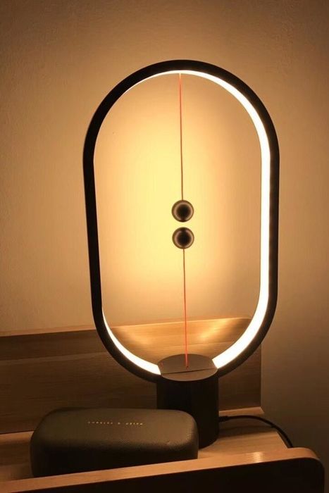 A snapshot from a reviewer showing the glowing lamp placed on a small side table