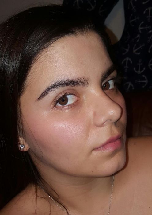 A reviewer showing off their clear, hydrated skin after using the product