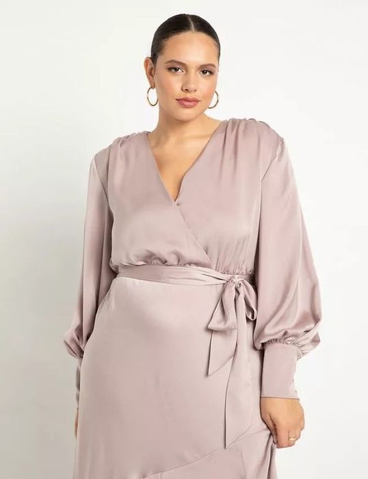 a close-up view of the beige dress