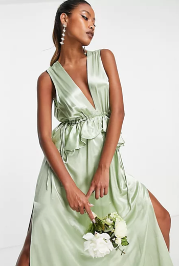 a close-up shot of the elegant sage-colored gown