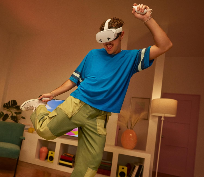 A person immersed in a wireless virtual reality experience while wearing a VR headset in their living room. Text reads: