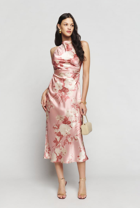 a model wearing the pink floral dress in a pose