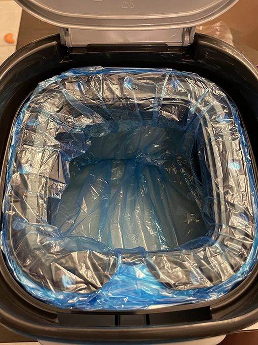 the interior of the Litter Genie, showing its blue plastic liner