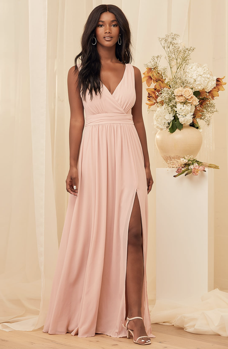 a model wearing the pink version of the dress