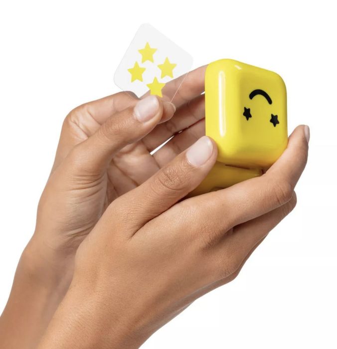 A person holding a sheet of pimple patches and the carrying case.