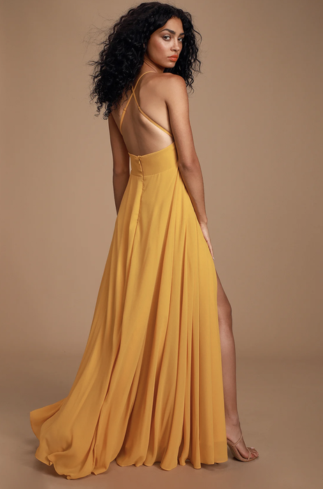 model demonstrating the back view of the dress in yellow