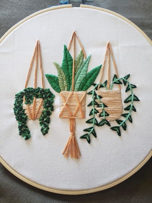 three embroidered plant designs in a hoop