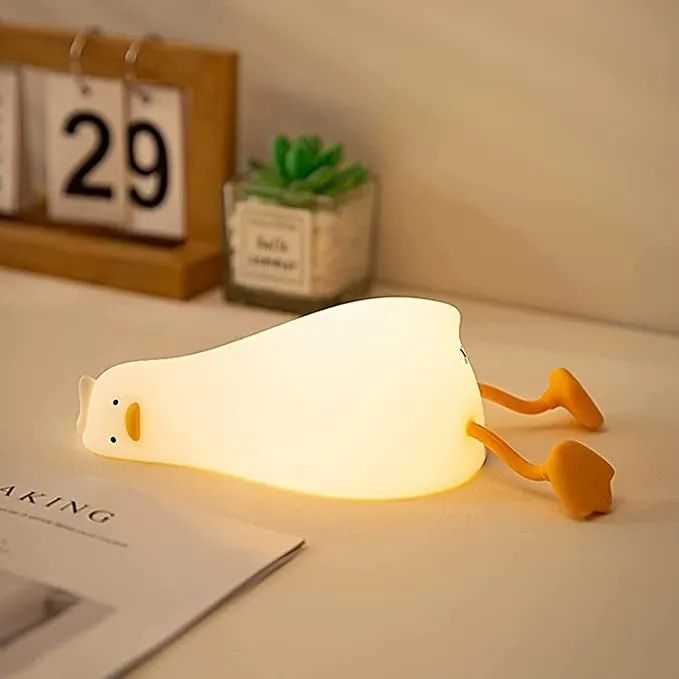 A glowing duck, lying on its side, with a face that screams deep existential dread