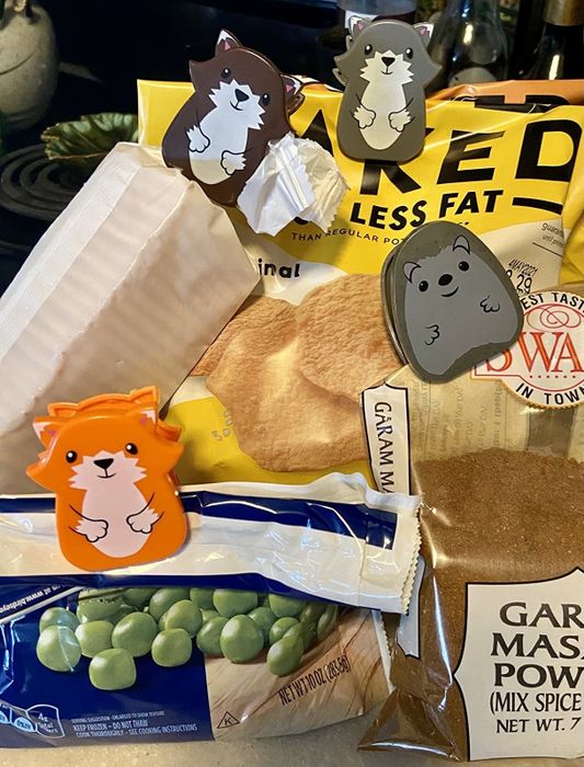 A variety of animal-shaped chip clips positioned on bags
