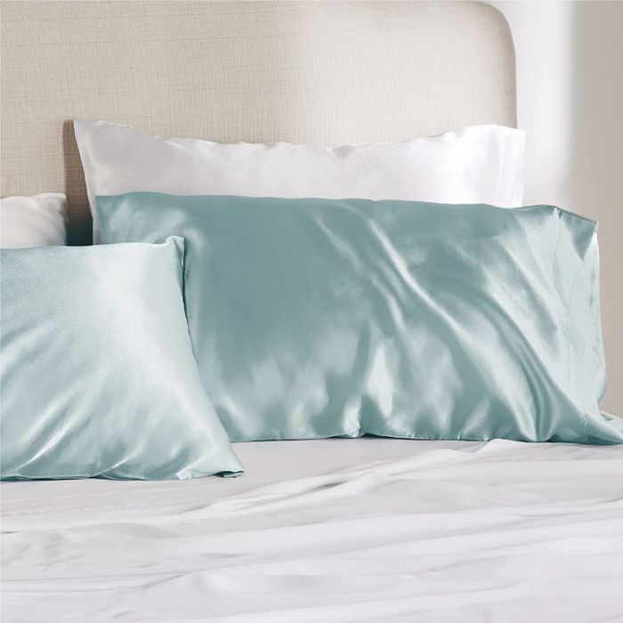 The pillowcases resting on a light blue bed