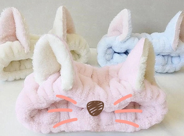 Cat headbands in green, blue, and pink, with the pink one featuring an adorable cat nose and whiskers design.