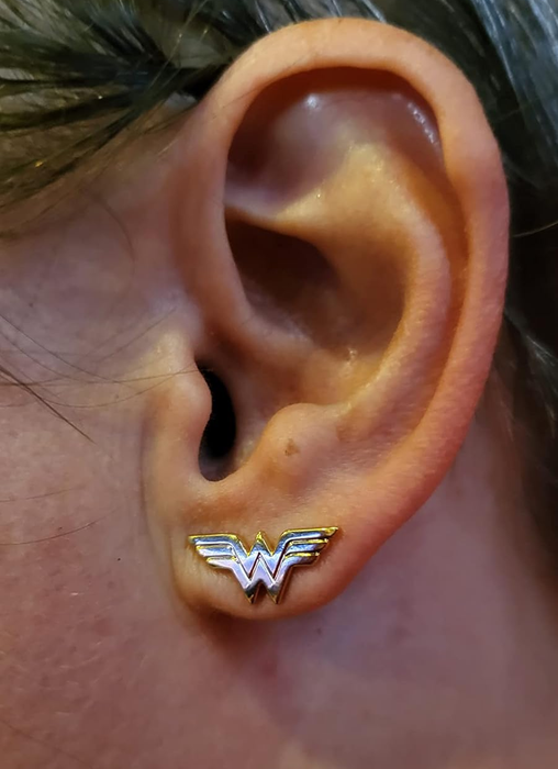 A reviewer showcasing the earrings