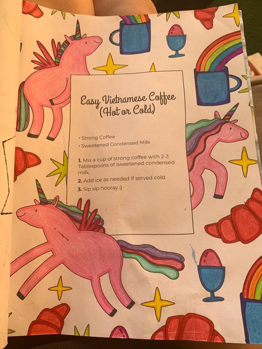 A reviewer's completed coloring page, featuring unicorns, rainbows, and a coffee recipe.