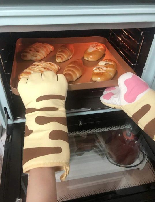 Cat-themed oven mitts with a cute pink paw design.