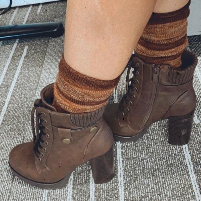 A reviewer shows off the brown style boots, perfect for fall and winter fashion.