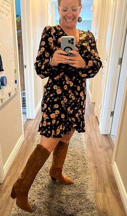 A reviewer sporting the brown suede boots.