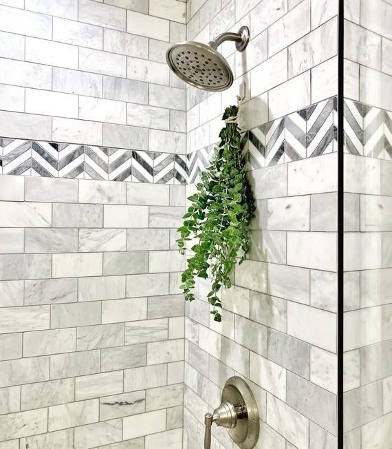 A large bundle of eucalyptus hanging in a shower