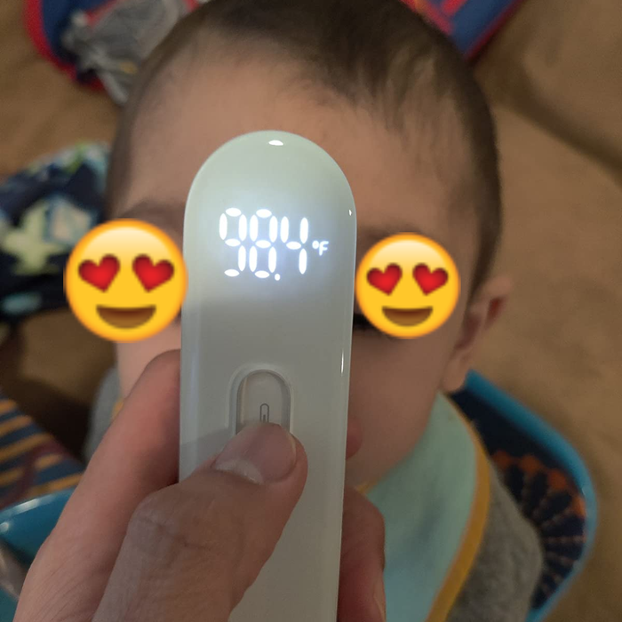 A reviewer using the thermometer to check their child's temperature, showcasing its easy-to-use functionality.