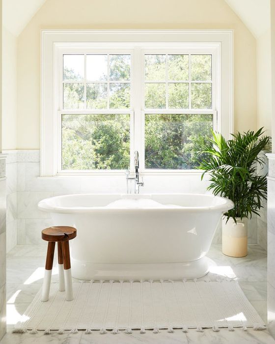 A white dip-dyed stool placed in a bathroom setting.