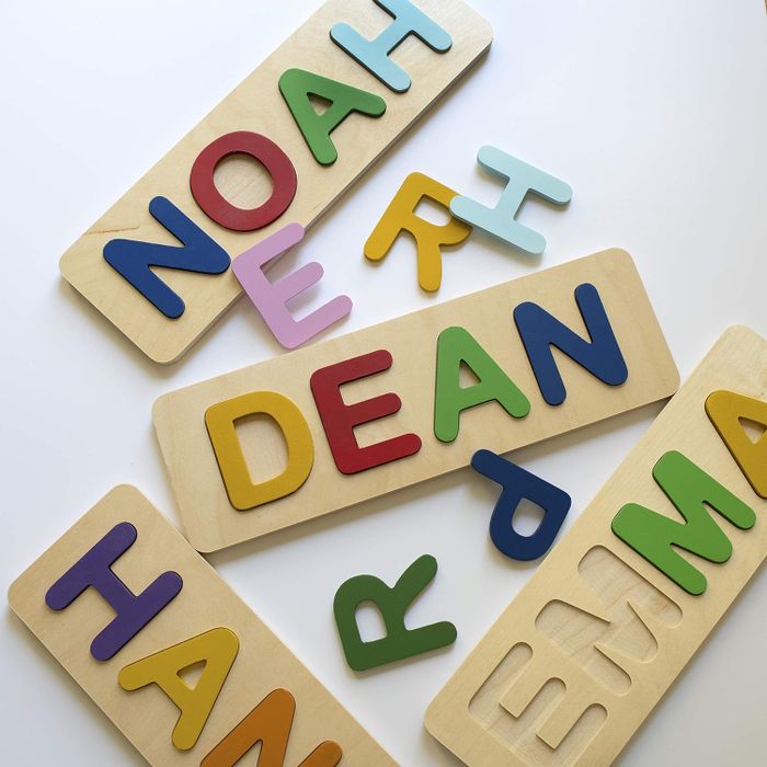 A set of personalized wooden name puzzles with colorful letters, designed for young children.