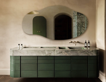 An asymmetrical mirror hung horizontally.