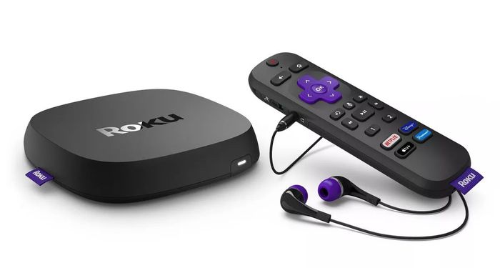 A Roku streaming device with a remote control and headphones