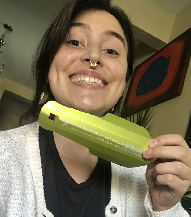 The writer smiling while holding a green Deuce trowel
