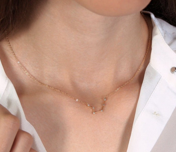 A necklace featuring a charm shaped like a zodiac constellation.
