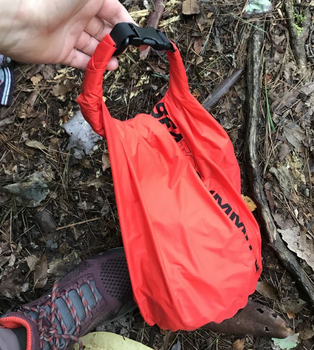 Red bag with a rolled and clipped top