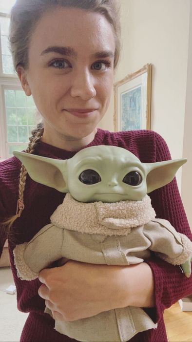 A Mytour editor snuggling her adorable Baby Yoda plushie.