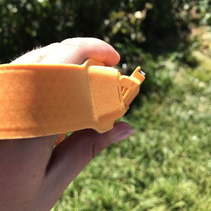 A writer demonstrating how the headlamp's flat light tilts downward.