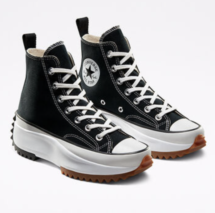 The black platform sneakers shown from a side angle