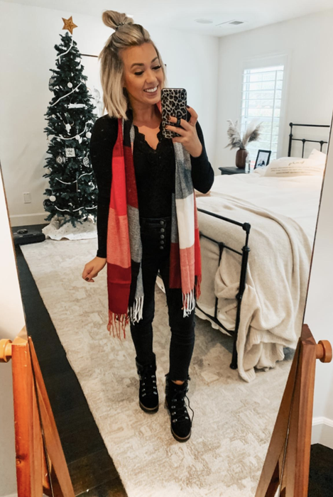 A reviewer sporting a large red, black, and gray scarf.