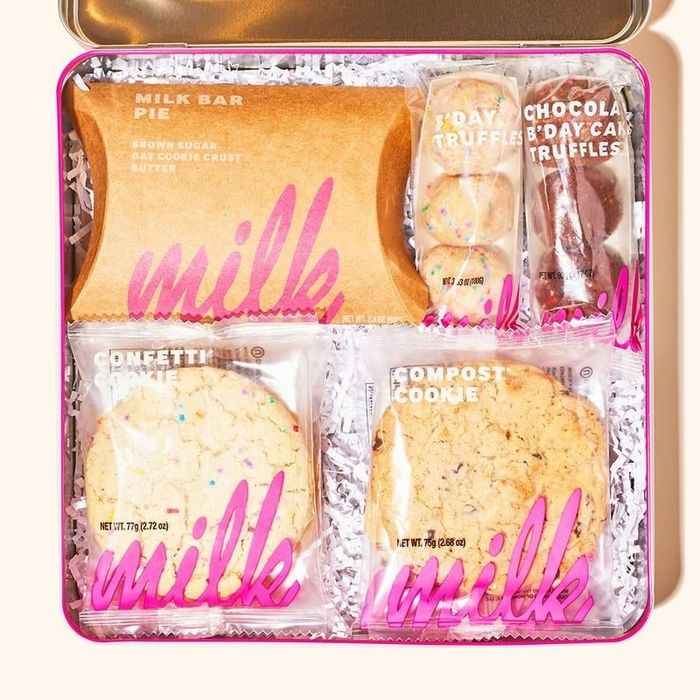 The sweet treats carefully arranged inside a Milk Bar tin.
