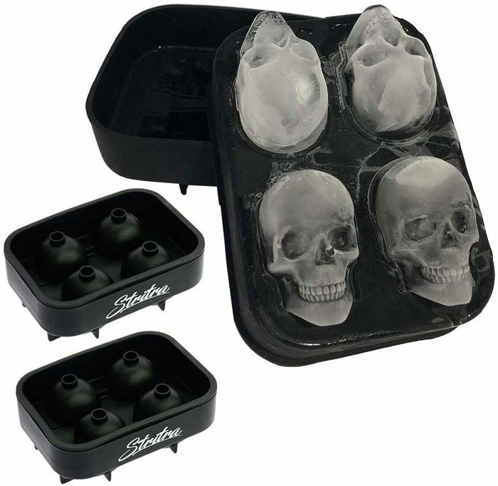Four skull-shaped ice cubes resting in the mold.