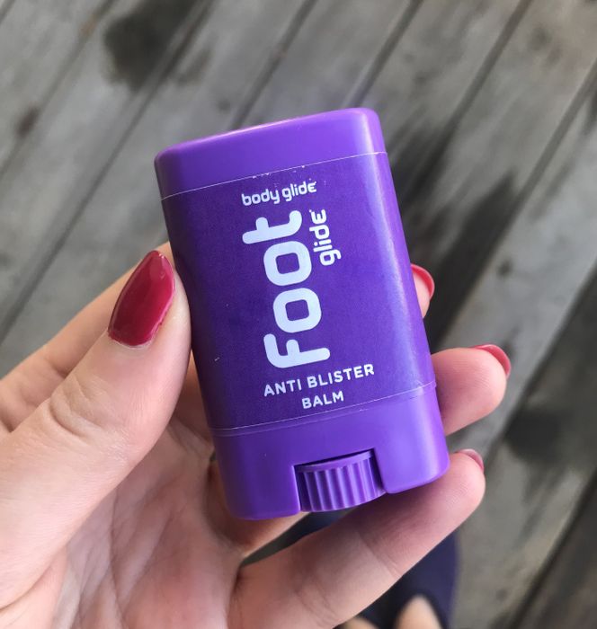 Writer holding a tiny purple tube of the balm