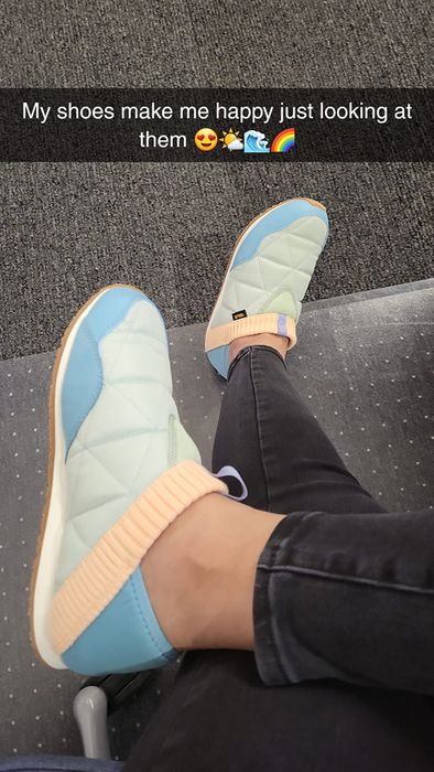 A person sitting with crossed legs, wearing trendy quilted slip-on sneakers. The overlay text reads,