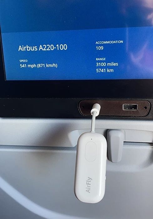 The AirFly Pro plugged into a screen on an airplane.